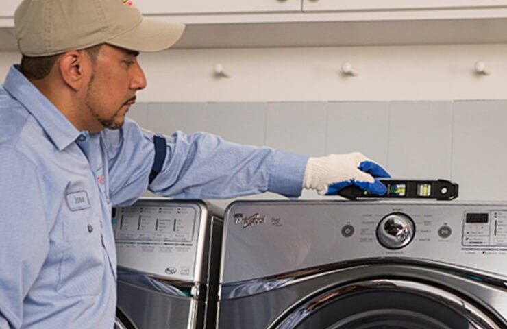 Worker installing a washer and dryer